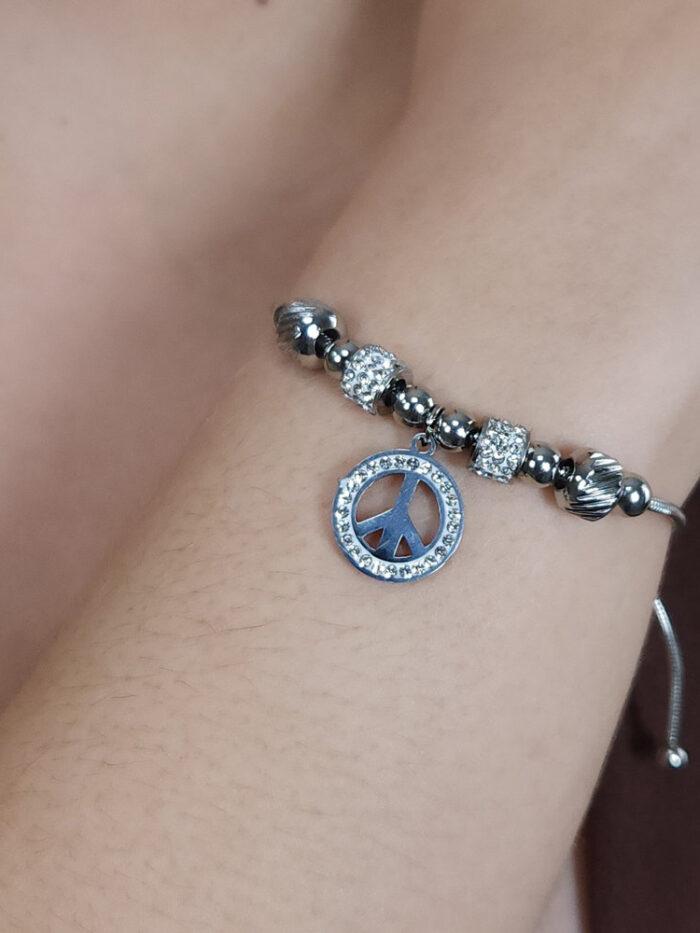 Pulseira bolas prateada e cravejada com pingente símbolo da paz