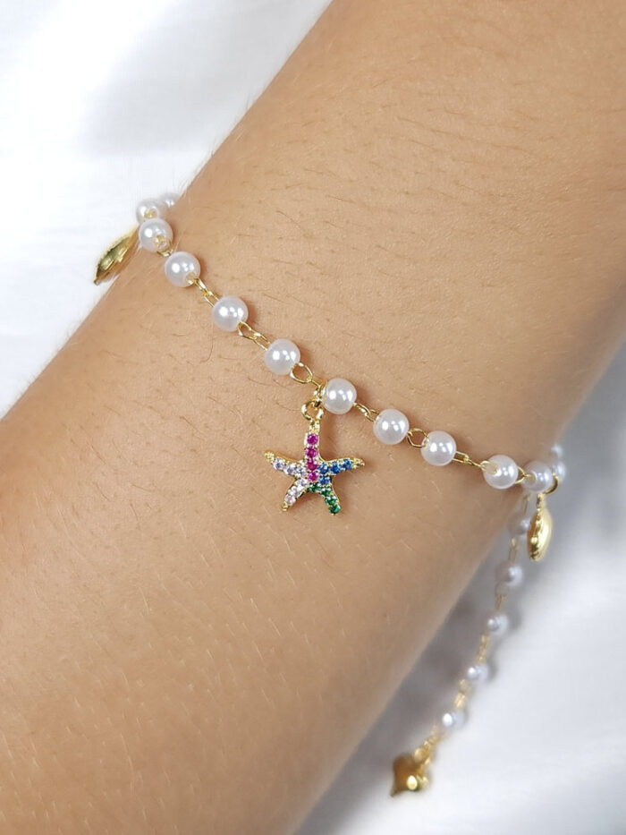 Pulseira pérola com estrela, concha e búzio