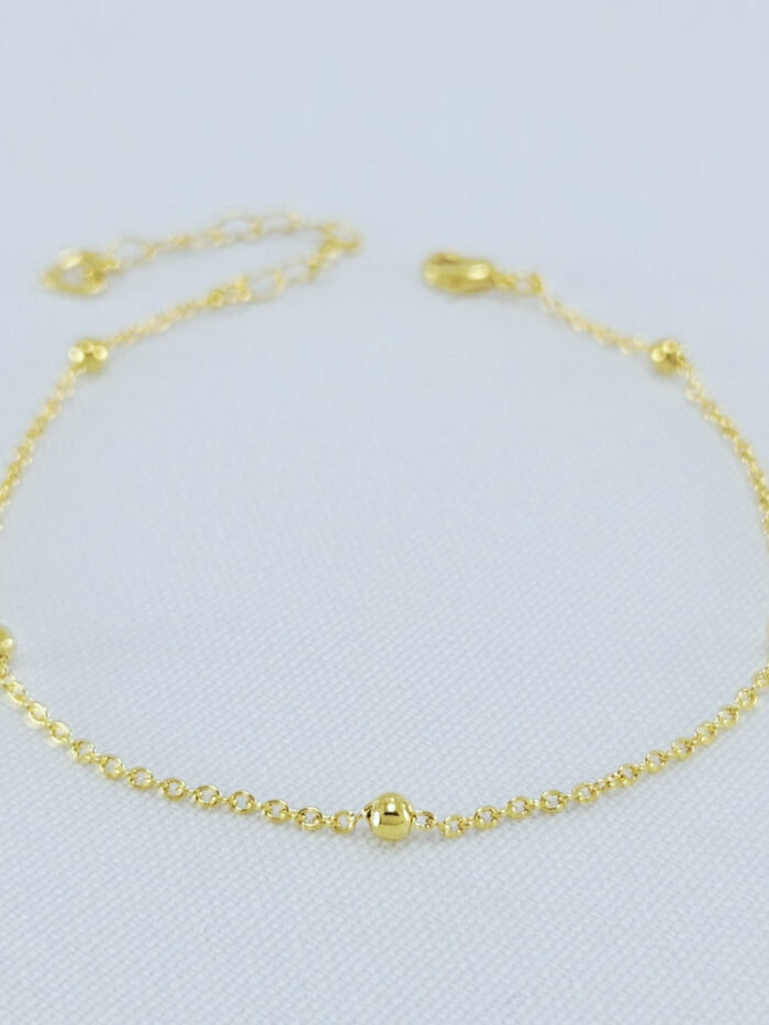 Pulseira com bolinhas douradas