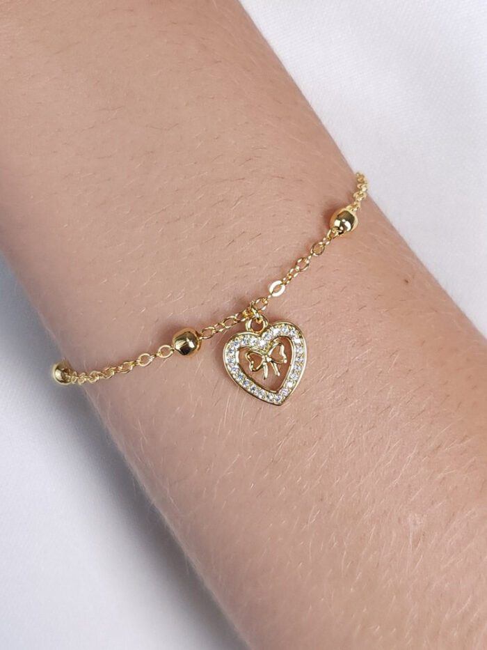 Pulseira coração cravejado detalhe laço