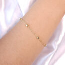 Pulseira elo americano com bolas douradas