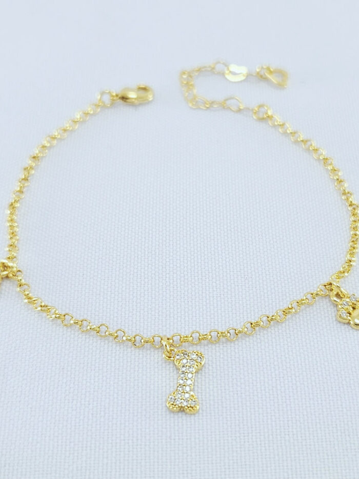 Pulseira patinhas e osso detalhe cravejado